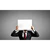 Businessman hiding his face behind paper list