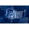 Two young designers are working on a new project in the night office using modern technology