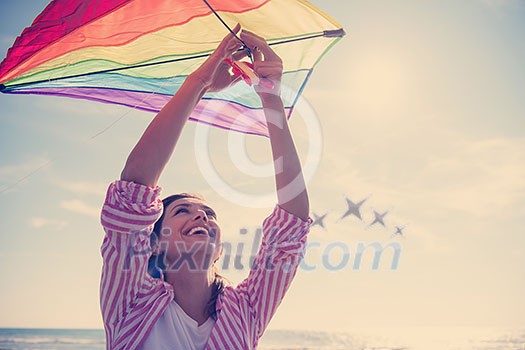 Beautiful Young Woman having fun with a kite at Beach on autumn day Beautiful Young Woman having fun with a kite at Beach on autumn day