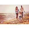 Family with kids resting and having fun at beach during autumn day filter