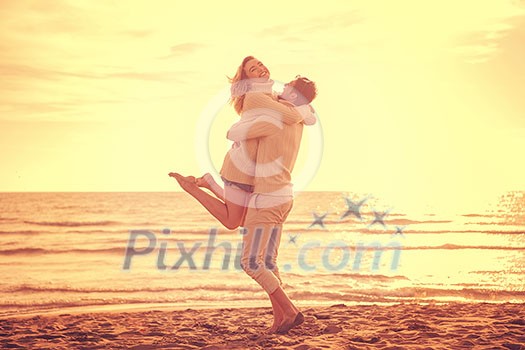 Young couple having fun walking and hugging on beach during autumn sunny day filter Young couple having fun walking and hugging on beach during autumn sunny day filter