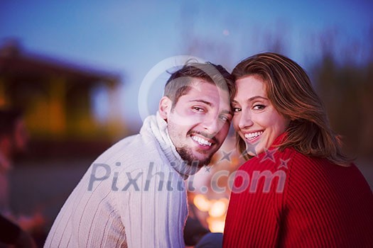 Young Couple enjoying with friends Around Campfire on The Beach At sunset drinking beer filter Young Couple enjoying with friends Around Campfire on The Beach At sunset drinking beer filter