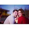 Young Couple enjoying with friends Around Campfire on The Beach At sunset drinking beer filter