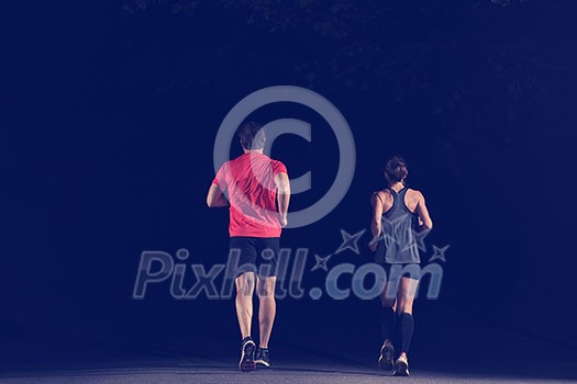 group of healthy people jogging in city park, runners team at night training group of healthy people jogging in city park, runners team at night training