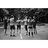 healthy runners team warming up and stretching in city park before morning training