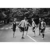 healthy runners team warming up and stretching in city park before morning training