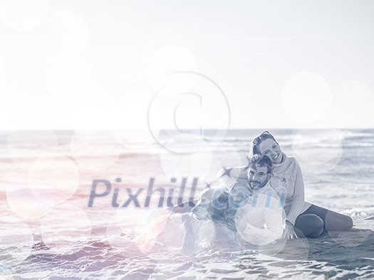 Couple With A Dog enjoying time together On The Beach at autumn day Couple With A Dog enjoying time together On The Beach at autumn day