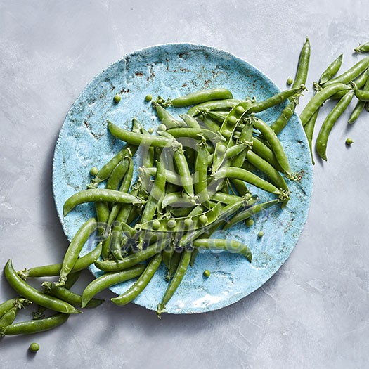 Pear sticks - organic green vegetables for preparing vegetarian salad on a blue plate on a gray table. Natural vegetarian detox dieting. Flat lay