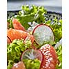 Homemade freshly salad from natural organic vegetables, fruits, cheese. Concept of healthy diet food. Close-up view with soft focus.