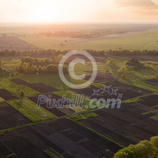 Farmland. Landscape view of the field and trees in the spring at sunset. Photo from the drone Farmland. Landscape view of the field and trees in the spring at sunset. Photo from the drone