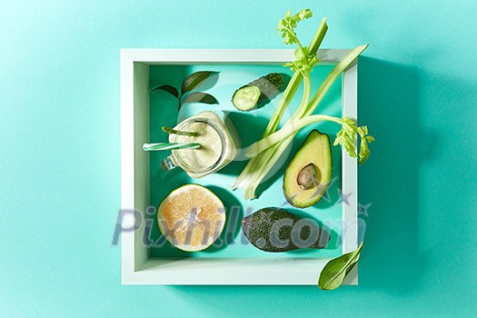Healthy smoothie from green vegetables and fruits with flax seeds in a white bowl in square frame on a green background with copy space. Dietary organic food. Healthy smoothie from green vegetables and fruits with flax seeds in a white bowl in square frame on a green background with copy space. Dietary organic food.