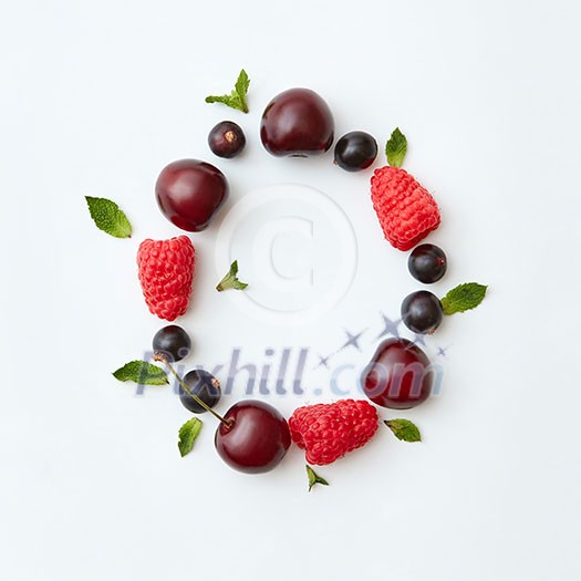 Letter O english alphabet in the form of a pattern of natural organic berries - ripe fresh raspberry, black currant, cherry, green mint leaf isolated on a white background. Flat lay. Letter O english alphabet in the form of a pattern of natural organic berries - ripe fresh raspberry, black currant, cherry, green mint leaf isolated on a white background. Flat lay.