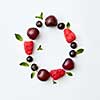 Letter O english alphabet in the form of a pattern of natural organic berries - ripe fresh raspberry, black currant, cherry, green mint leaf isolated on a white background. Flat lay.