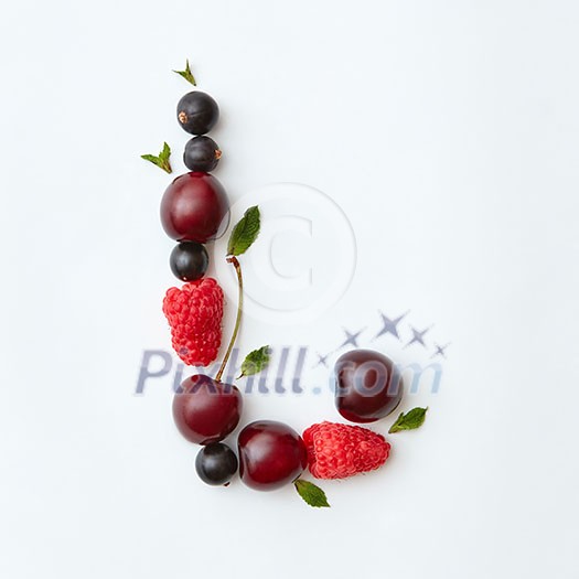 Letter L english alphabet in the form of a pattern of natural organic berries - ripe fresh raspberry, black currant, cherry, green mint leaf isolated on a white background. Top view. Letter L english alphabet in the form of a pattern of natural organic berries - ripe fresh raspberry, black currant, cherry, green mint leaf isolated on a white background. Top view.