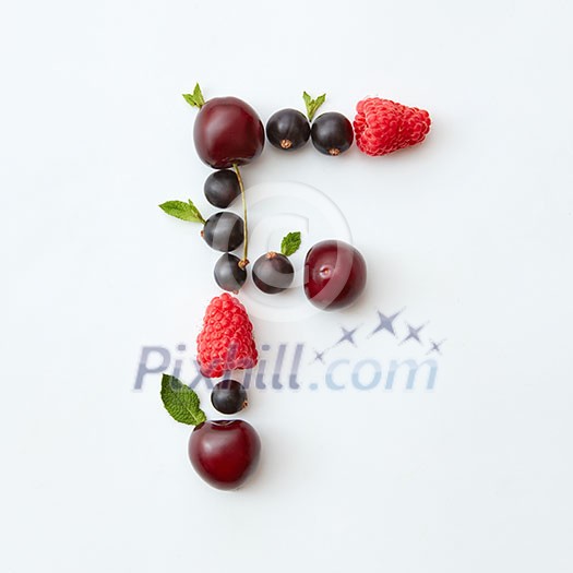 Letter F english alphabet in the form of a pattern of natural organic berries - ripe fresh raspberry, black currant, cherry, green mint leaf isolated on a white background. Top view. Letter F english alphabet in the form of a pattern of natural organic berries - ripe fresh raspberry, black currant, cherry, green mint leaf isolated on a white background. Top view.