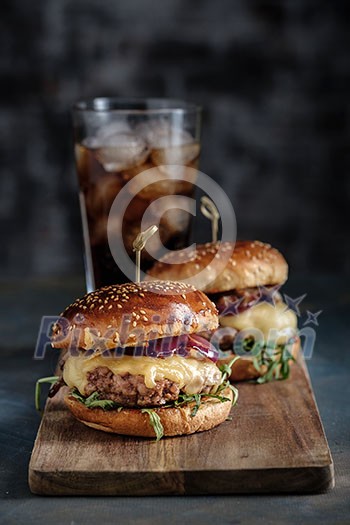 Homemade juicy burgers with beef, cheese and caramelized onions. Street food, fast food. Homemade juicy burgers with beef, cheese and caramelized onions. Street food, fast food.