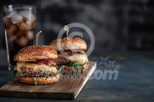 Homemade tasty hamburger with beef, cheese and caramelized onions. Street food, fast food. Copyspace. Homemade tasty hamburger with beef, cheese and caramelized onions. Street food, fast food. Copyspace.