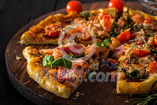 Delicious homemade fresh pizza with shrimps and bacon. Close-up.