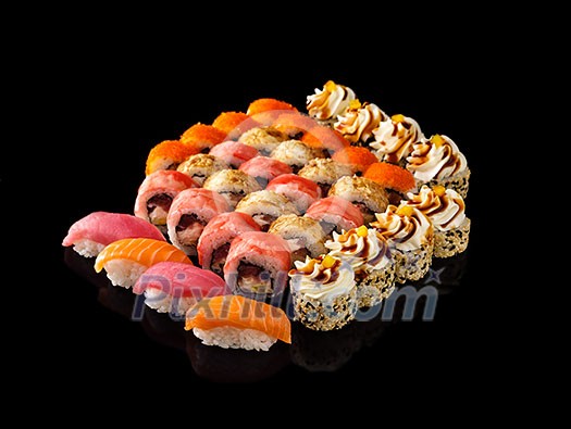 Fresh Sushi rolls set served on black background. Japanese seafood sushi.