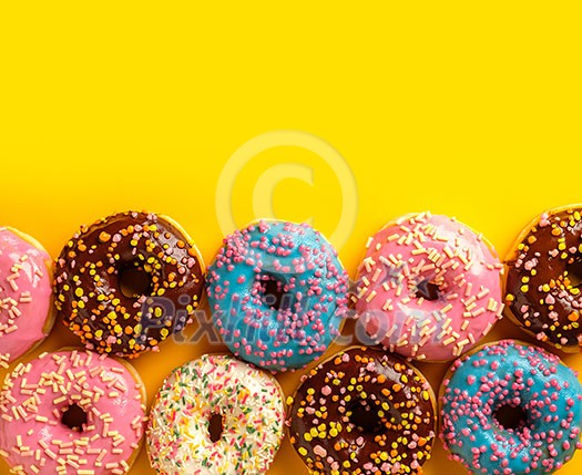 Variety of colorful tasty glazed donuts on a colored background. Variety of colorful tasty glazed donuts on a colored background.