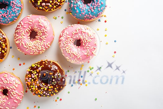 Variety of colorful tasty glazed donuts on a white background. Variety of colorful tasty glazed donuts on a white background.
