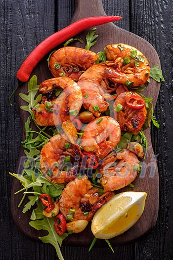 Large grilled BBQ shrimp with sweet chili sauce, green onion and lemon Large grilled BBQ shrimp with sweet chili sauce, green onion and lemon