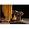Freshly prepared Tagliatelle paste is dried on a wooden drier. Traditional italian cuisine.