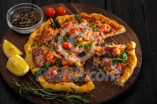 Delicious homemade fresh pizza with shrimps and bacon. Delicious homemade fresh pizza with shrimps and bacon.