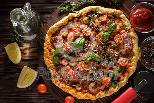 Delicious homemade fresh pizza with shrimps and bacon. Top view. Delicious homemade fresh pizza with shrimps and bacon. Top view.