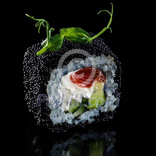 Close-up of traditional japanese sushi on a dark background with reflection. Salmon with Philadelphia cheese and black caviar Close-up of traditional japanese sushi on a dark background with reflection. Salmon with Philadelphia cheese and black caviar