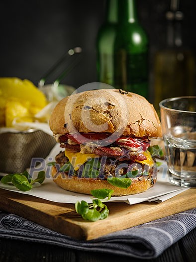 Homemade juicy burger with beef, bacon, cheese and bulgarian pepper. Street food, fast food. Homemade juicy burger with beef, bacon, cheese and bulgarian pepper. Street food, fast food.