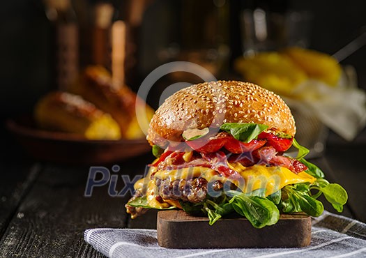 Homemade juicy burger with beef, bacon, cheese and bulgarian pepper. Street food, fast food. Homemade juicy burger with beef, bacon, cheese and bulgarian pepper. Street food, fast food.