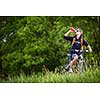Handsome young man biking in the countryside