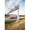 truck passing through a toll gate on a highway (motion blurred image; color toned image)