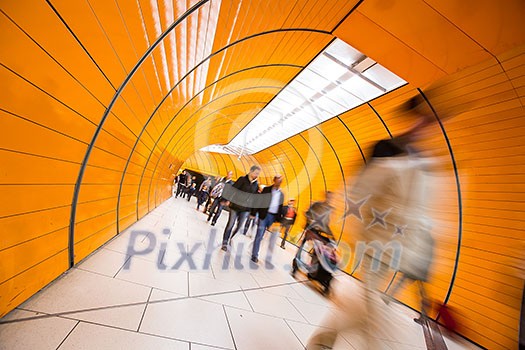 People rushing through a subway corridor (motion blur technique is used to convey movement) People rushing through a subway corridor (motion blur technique is used to convey movement)