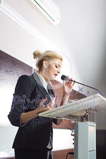 Pretty, young business woman giving a presentation in a conference/meeting setting (shallow DOF; color toned image) Pretty, young business woman giving a presentation in a conference/meeting setting (shallow DOF; color toned image)