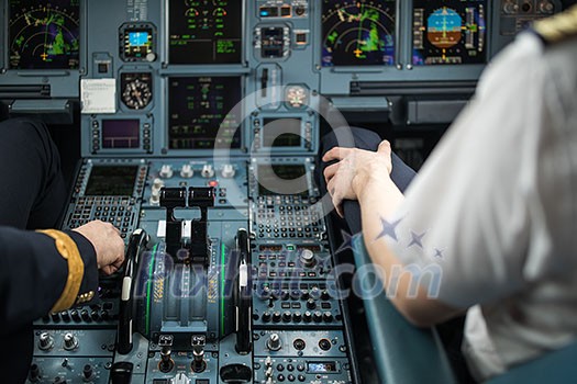 Pilot's hand accelerating on the throttle in a commercial airliner airplane flight cockpit during takeoff Pilot's hand accelerating on the throttle in a commercial airliner airplane flight cockpit during takeoff