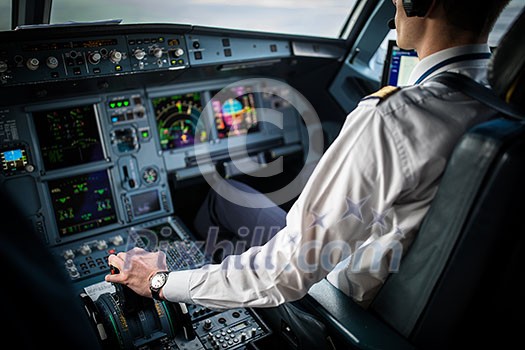 Pilot's hand accelerating on the throttle in a commercial airliner airplane flight cockpit during takeoff Pilot's hand accelerating on the throttle in a commercial airliner airplane flight cockpit during takeoff