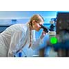 Portrait of a female researcher carrying out research in a chemistry lab (color toned image; shallow DOF)