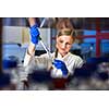 Portrait of a female researcher carrying out research in a chemistry lab (color toned image; shallow DOF)