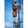 Ski lift with skiers being carried up the hill on a lovely, sunny winter day