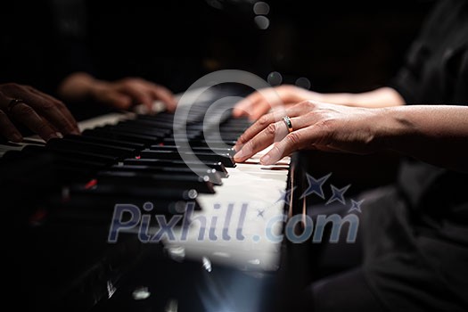 Close up of hands of a female piano player Close up of hands of a female piano player