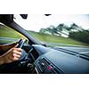Man driving a car moving fast on a highway (motion blurred image)