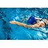 Female swimmer in an indoor swimming pool - doing crawl (shallow DOF)