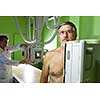 Healthcare Concept - Senior male patient undergoing an X-ray examination in a modern hospital