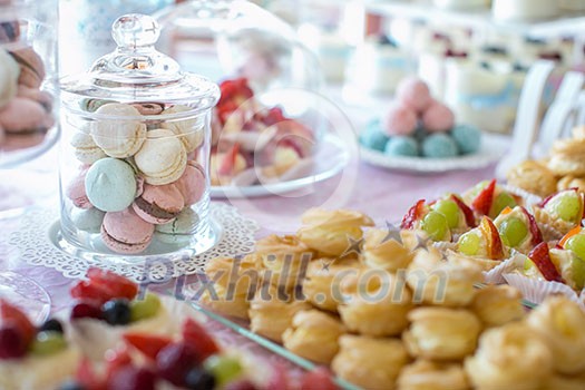 Table setting. Colorful macarons and cakes. Table setting. Colorful macarons and cakes.