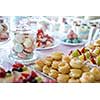 Table setting. Colorful macarons and cakes.