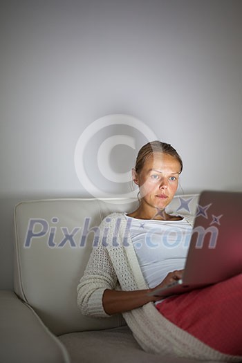 Very tired young woman, burning the midnigh oil - working late at night on her laptop computer, at home, sitting on sofa, rubbing her tired eyes, trying to stay focused Very tired young woman, burning the midnigh oil - working late at night on her laptop computer, at home, sitting on sofa, rubbing her tired eyes, trying to stay focused