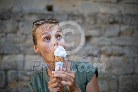 Woman eating ice cream outside on summer vacation in holiday beach resort. Woman eating ice cream outside on summer vacation in holiday beach resort.