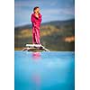 Little girl on a pool's edge, learning to swim and dive. Swimming with kids. Healthy sport activity for children. Sun protection. Water fun.